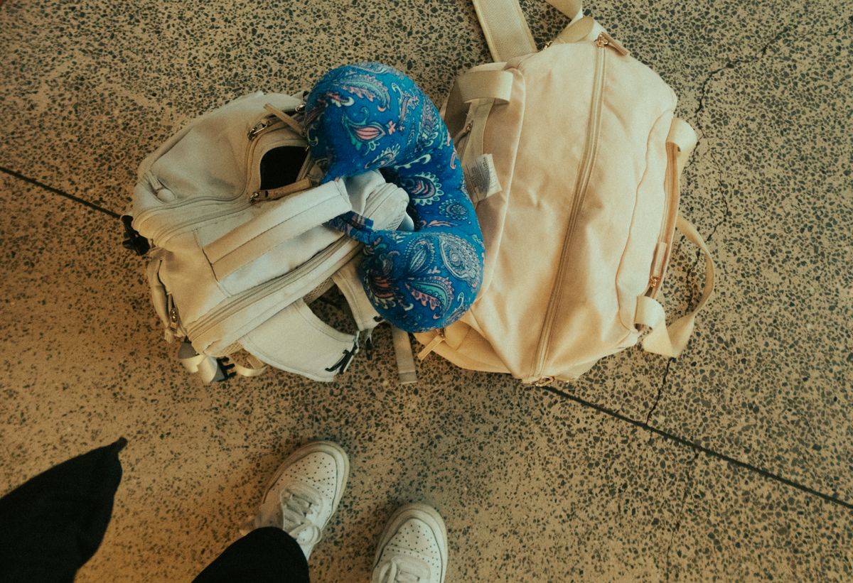 Luggage, backpack and neck pillow ready for an airport journey