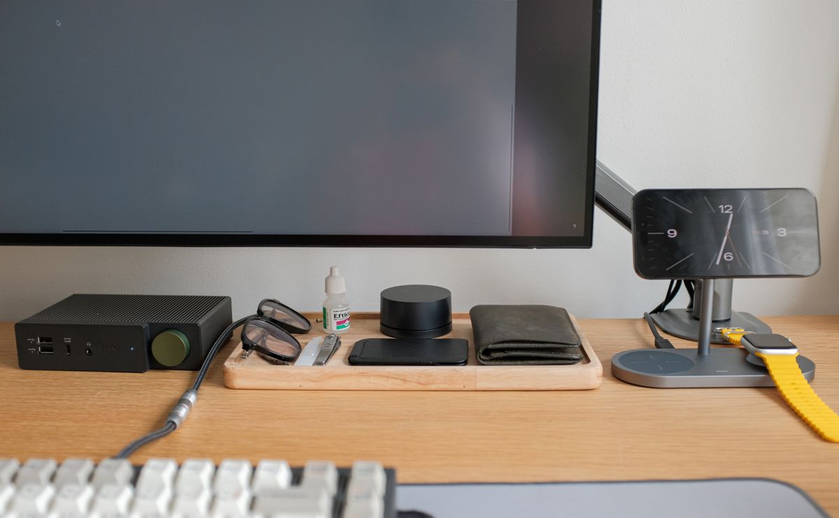 A home desk with a monitor, keyboard and everyday accessories